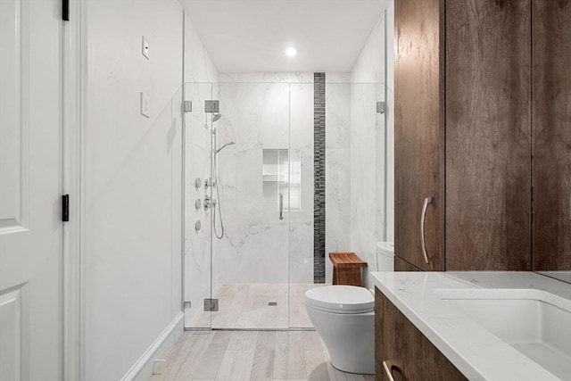 42 Coolidge St Unit 42, Brookline, MA 02446 - bathroom with toilet, a marble finish shower, vanity, and recessed lighting