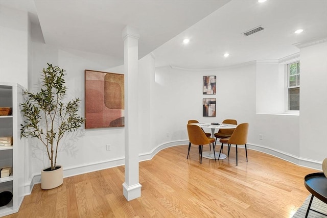42 Coolidge St Unit 42, Brookline, MA 02446 - dining space with light wood-style flooring, recessed lighting, crown molding, baseboards, and decorative columns