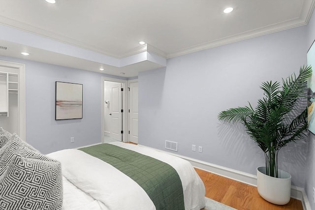 42 Coolidge St Unit 42, Brookline, MA 02446 - bedroom with crown molding, recessed lighting, wood finished floors, baseboards, and a walk in closet