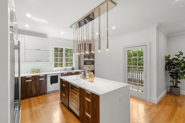 42 Coolidge St Unit 42, Brookline, MA 02446 - kitchen with modern cabinets, wine cooler, dishwasher, crown molding, and plenty of natural light