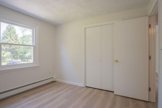 6 Marshall Rd, Beverly, MA 01915 - unfurnished bedroom featuring a baseboard radiator, light wood-style floors, and a closet