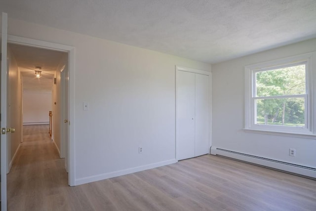 6 Marshall Rd, Beverly, MA 01915 - unfurnished bedroom featuring wood finished floors, a baseboard radiator, and a closet