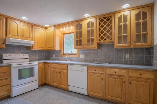 6 Marshall Rd, Beverly, MA 01915 - kitchen featuring white appliances, under cabinet range hood, light tile patterned floors, glass insert cabinets, and decorative backsplash