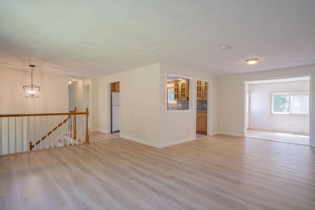 6 Marshall Rd, Beverly, MA 01915 - spare room with light wood-style flooring and a chandelier