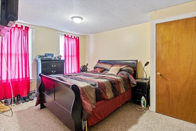 bedroom featuring carpet floors and a textured ceiling