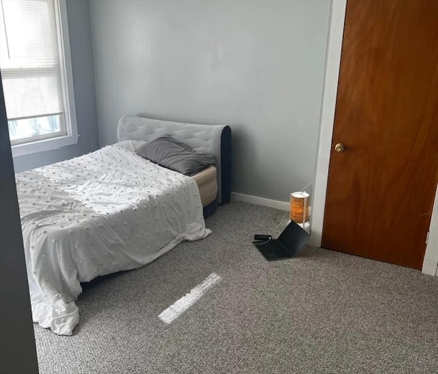 carpeted bedroom with baseboards