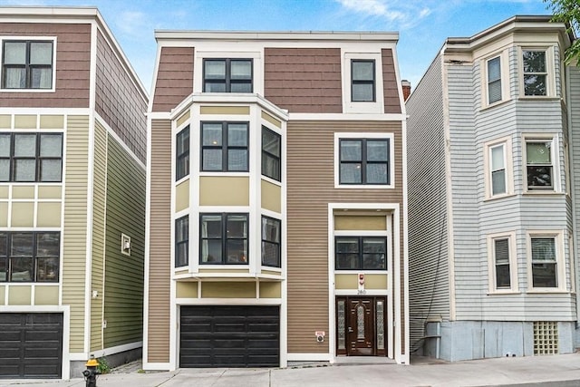 280 W 5th St Unit 101, Boston, MA 02127 - view of front facade with concrete driveway and an attached garage
