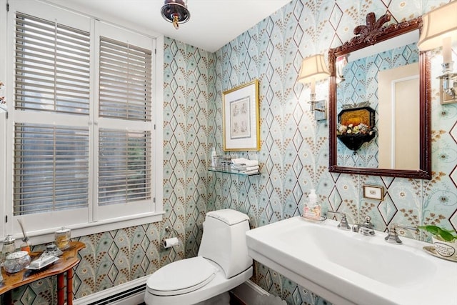 228 Allandale Rd Unit 1A, Boston, MA 02467 - bathroom featuring a sink, a baseboard heating unit, and toilet