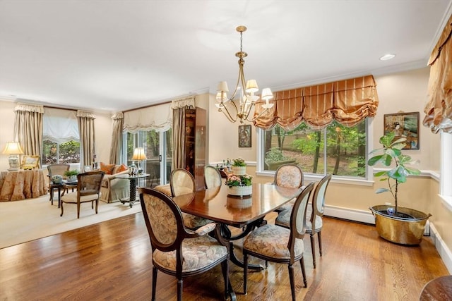 228 Allandale Rd Unit 1A, Boston, MA 02467 - dining area with a chandelier, wood finished floors, a baseboard heating unit, and baseboards