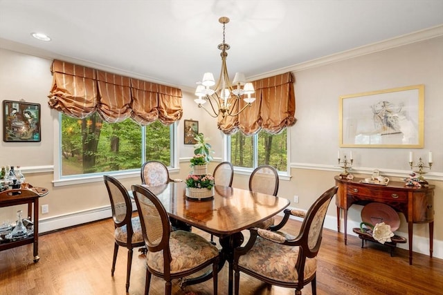 228 Allandale Rd Unit 1A, Boston, MA 02467 - dining area with a baseboard radiator, a chandelier, light wood-style flooring, crown molding, and baseboards