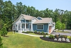 view of front of property featuring a garage and a front lawn