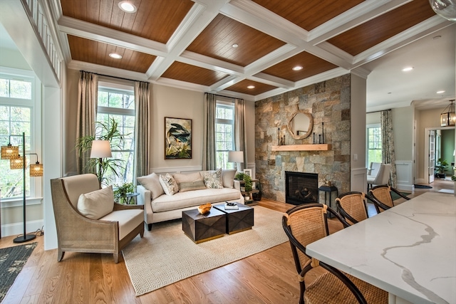 living room with a fireplace, coffered ceiling, wood ceiling, light hardwood / wood-style floors, and beamed ceiling