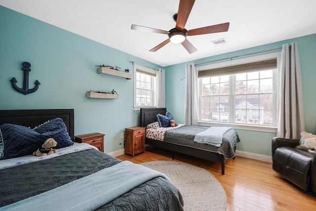 bedroom with ceiling fan and light hardwood / wood-style floors