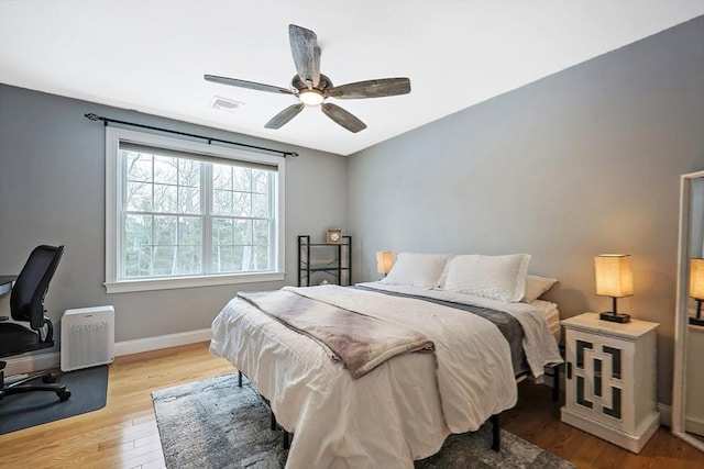 bedroom with ceiling fan and light hardwood / wood-style flooring