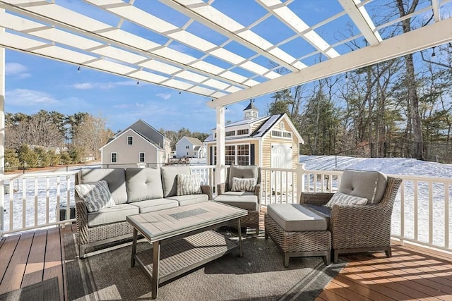 snow covered deck with an outdoor hangout area and a pergola