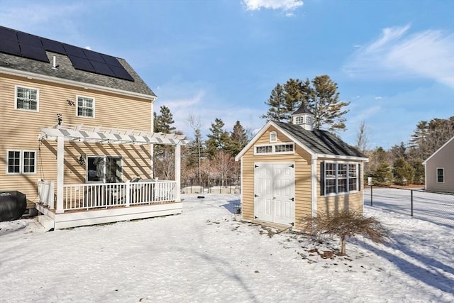 exterior space with a pergola and solar panels