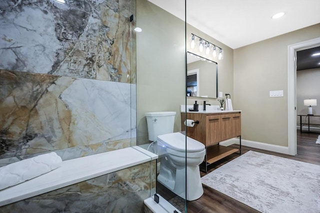 bathroom with wood-type flooring, vanity, and toilet