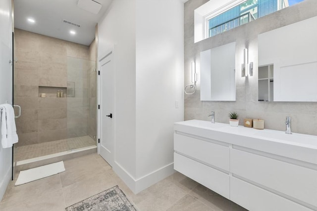 21 Eastman Rd Unit 0, Somerville, MA 02143 - bathroom with double vanity, a stall shower, tile patterned flooring, and recessed lighting