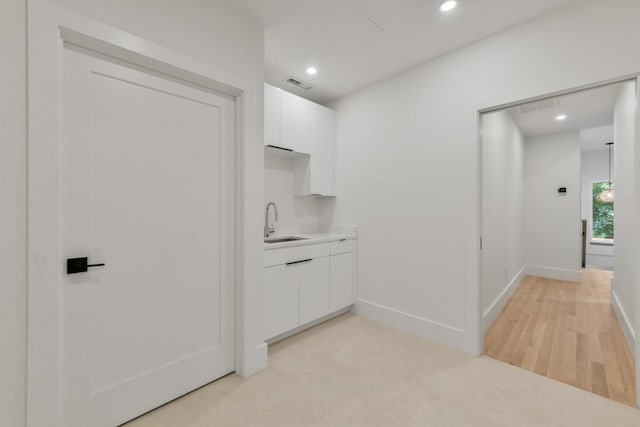 21 Eastman Rd Unit 0, Somerville, MA 02143 - kitchen with white cabinets, modern cabinets, recessed lighting, light countertops, and light wood-style floors