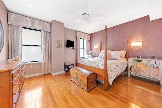 bedroom featuring light wood-style floors, baseboards, and ceiling fan