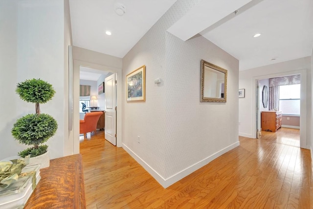 hall featuring recessed lighting, baseboards, and light wood-style floors