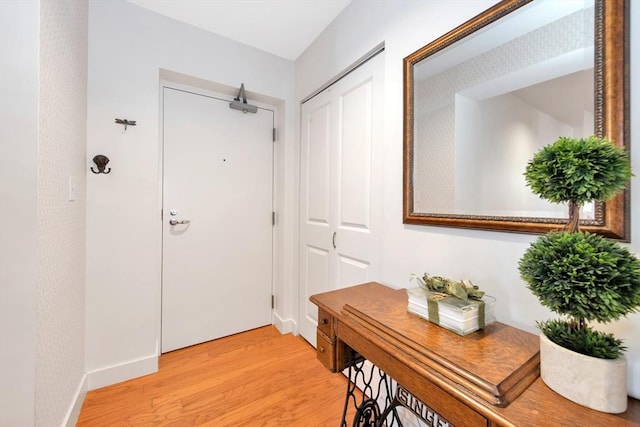 interior space featuring light wood-type flooring and baseboards