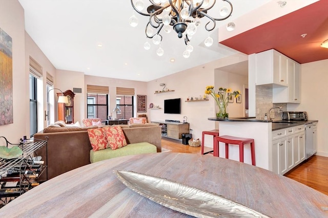 dining room featuring light wood-style floors, recessed lighting, and a chandelier
