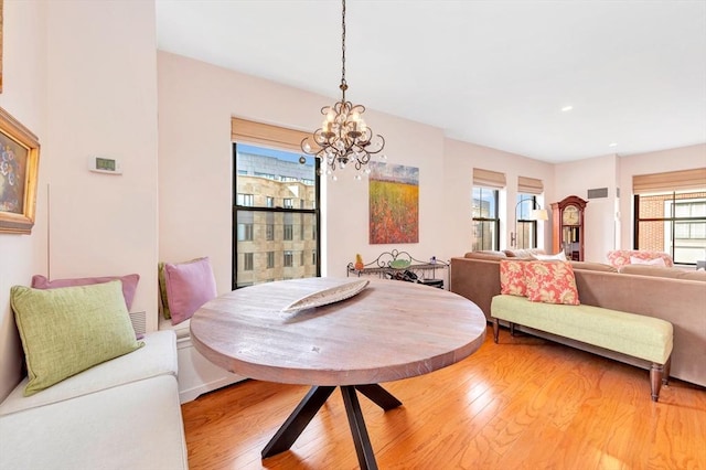 dining area featuring recessed lighting, visible vents, light wood finished floors, and a notable chandelier