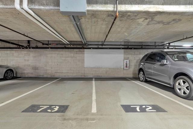 parking garage featuring concrete block wall