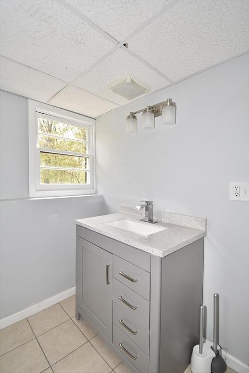 bathroom with tile patterned floors, visible vents, and vanity