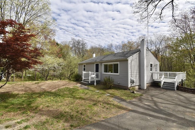 bungalow with a chimney and a deck