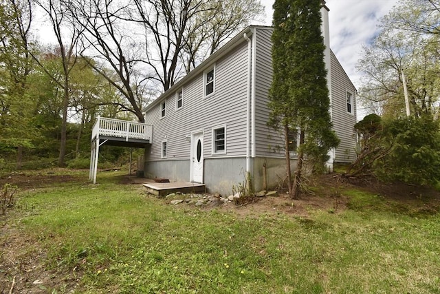 view of side of home featuring a wooden deck and a chimney