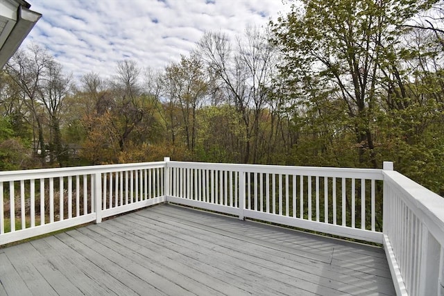wooden terrace with a view of trees