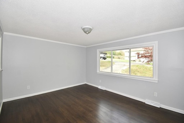 empty room featuring visible vents, crown molding, baseboards, dark wood-style floors, and a textured ceiling