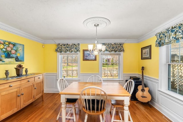 86 Whitney, Northborough, MA 01532 - dining space with a chandelier, light wood-style floors, ornamental molding, wainscoting, and a decorative wall