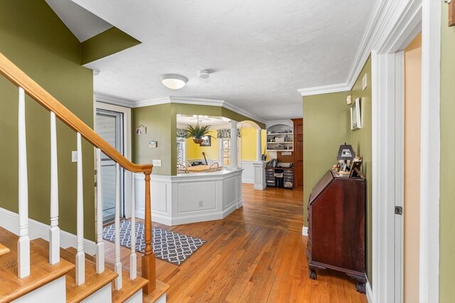 86 Whitney, Northborough, MA 01532 - foyer featuring arched walkways, hardwood / wood-style floors, crown molding, stairs, and a textured ceiling