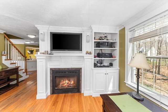 86 Whitney, Northborough, MA 01532 - living room featuring light wood-style flooring, a fireplace, crown molding, and stairway