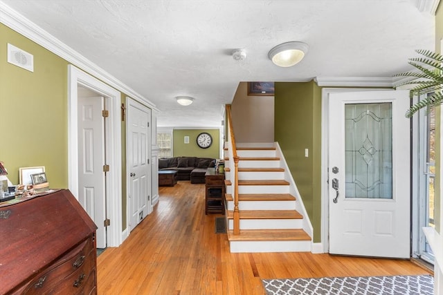 86 Whitney, Northborough, MA 01532 - foyer featuring stairway, light wood finished floors, ornamental molding, and baseboards