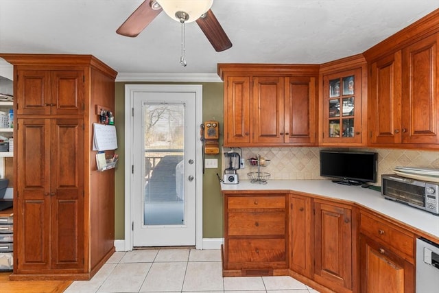 86 Whitney, Northborough, MA 01532 - kitchen featuring tasteful backsplash, light countertops, ceiling fan, light tile patterned flooring, and brown cabinets