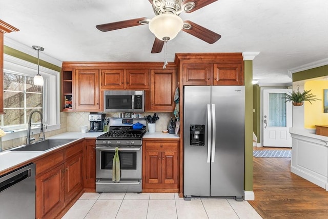 86 Whitney, Northborough, MA 01532 - kitchen featuring appliances with stainless steel finishes, a sink, light countertops, crown molding, and decorative backsplash