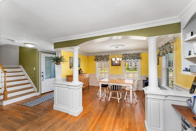 86 Whitney, Northborough, MA 01532 - dining room with ornate columns, light wood-style flooring, wainscoting, crown molding, and stairs