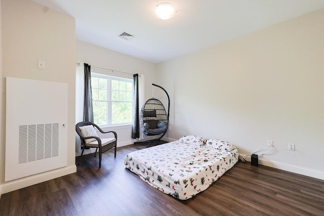 bedroom featuring wood finished floors and baseboards