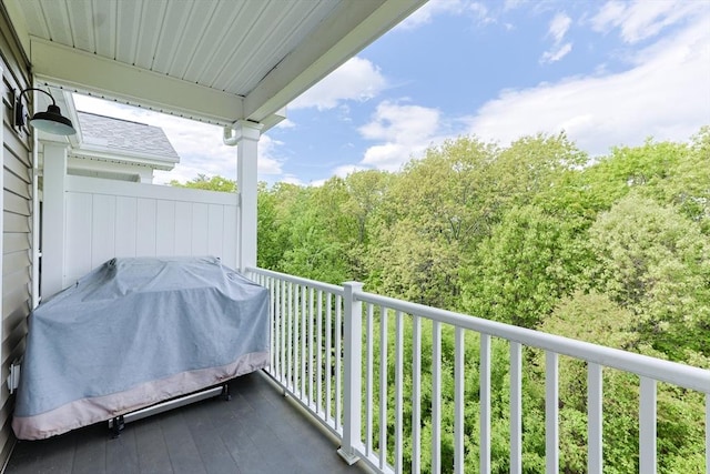 balcony with a grill and a view of trees