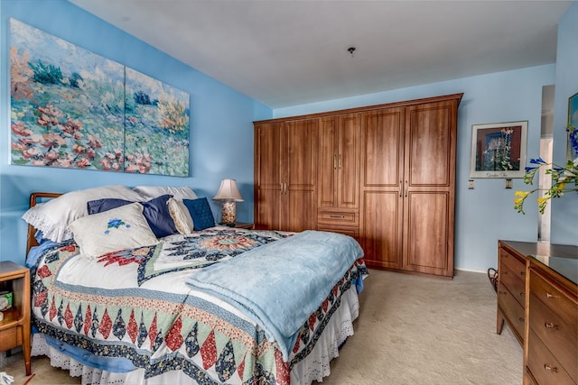 bedroom featuring light colored carpet