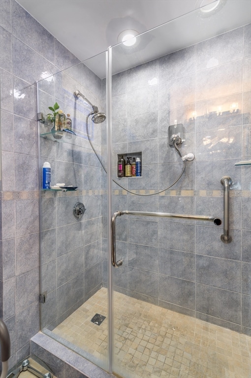 bathroom featuring a shower with shower door