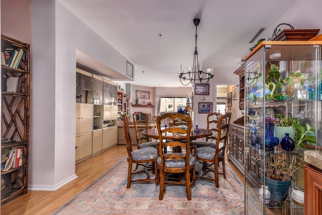 dining room with an inviting chandelier and light hardwood / wood-style floors