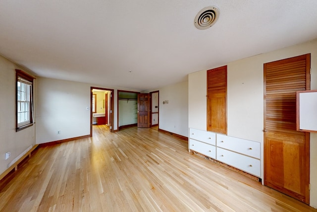 interior space featuring light hardwood / wood-style floors and ensuite bath