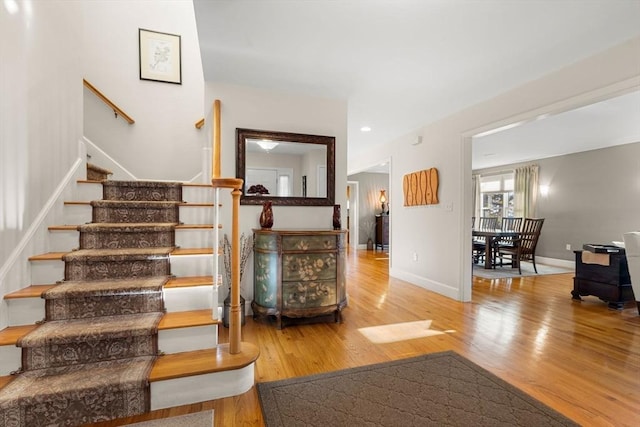 staircase with hardwood / wood-style flooring