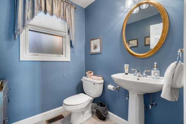 bathroom featuring tile patterned flooring and toilet