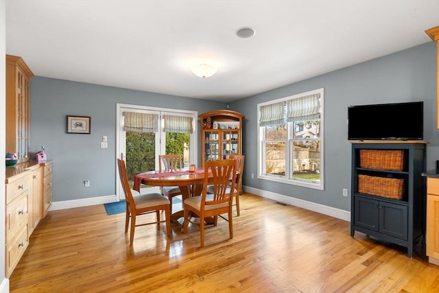 dining space with light hardwood / wood-style flooring